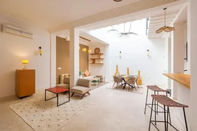 a living room with a table and chairs at Riad 2 chambres & Petit Déjeuner - Wifi - Top Location Médina in Marrakech
