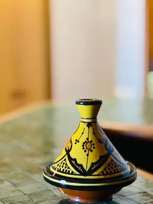 a yellow and black vase sitting on a table at Pavillon du Golf - Palmeraie suites in Marrakech