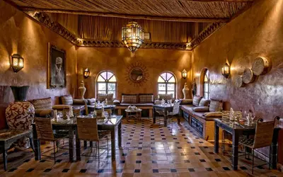 a restaurant with tables and chairs in a room at Hotel Kasbah Le Mirage & Spa in Marrakech