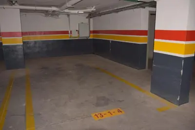 an empty parking garage with a yellow tape on the floor at Magnifique appartement à Riad Garden in Marrakech
