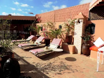 a group of lounge chairs sitting on a patio at Riad Adriana in Marrakech
