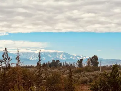 a view of snow covered mountains in the distance at La Ferme des Tipis Marrakech in Marrakech