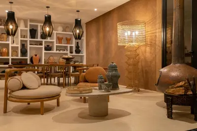 a room with chairs and a table and a lamp at Villa Ecolodge DAR LOUMA in Marrakech