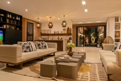 a living room with two couches and a tv at Villa Ecolodge DAR LOUMA in Marrakech
