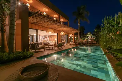 a house with a swimming pool at night at Villa Ecolodge DAR LOUMA in Marrakech