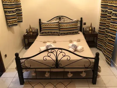 a bedroom with a bed with pillows on it at Riad Jasmine in Marrakech