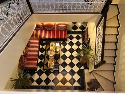 a staircase with a checkered floor and plants at Riad Jasmine in Marrakech