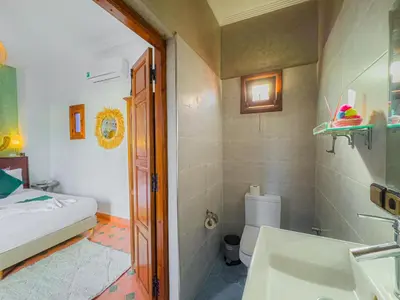 a bathroom with a sink and a toilet at Riad L'Orchidée Suites & Spa in Marrakech