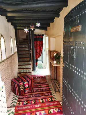 a hallway with colorful carpeted stairs in a house at Riad Dowaya in Marrakech