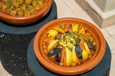 two bowls of food with beans and vegetables at Riad Dowaya in Marrakech