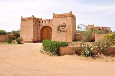 a building in the middle of a dirt road at La Maison Des Oliviers in Marrakech