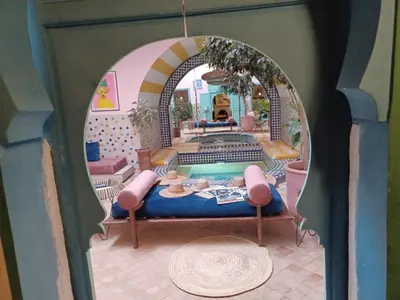 a room with a bed and a swimming pool at Riad Lauriers Blancs in Marrakech
