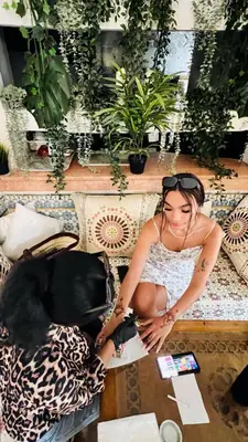 a woman sitting on a couch with a dog at Riad Al Mamoune in Marrakech