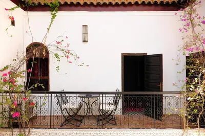 a white house with a balcony with a black gate at Riad Al Mamoune in Marrakech