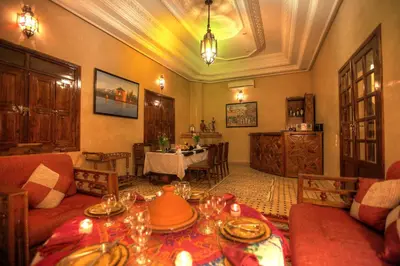 a living room with a table with dishes on it at Villa Dar Mya Palmiers in Marrakech