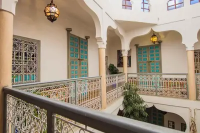 a balcony of a building with blue shutters at Riad Zinoun & Spa 11 Rooms in Marrakech