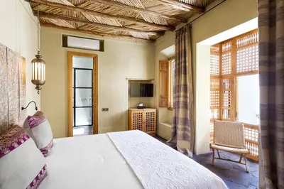 a bedroom with a bed and a large window at Ryad Dyor in Marrakech