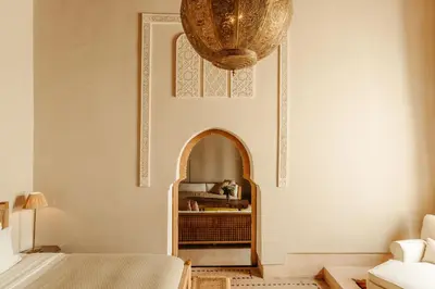 a room with a bed and a chandelier at Ryad Dyor in Marrakech