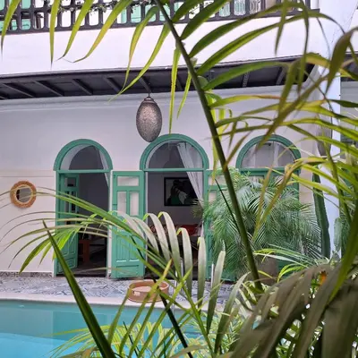 a house with a green door and some plants at Riad El Grably in Marrakech