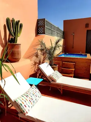 a room with two couches and a table with plants at Riad Dar Zouar & Spa in Marrakech