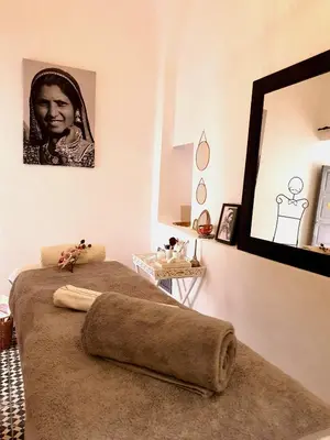 a room with a bed with a mirror on the wall at Riad Dar Zouar & Spa in Marrakech