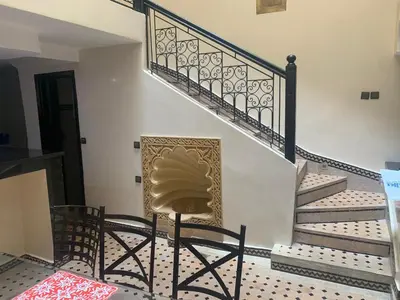 a chair sitting in the middle of a staircase at Riad jmiaa in Marrakech