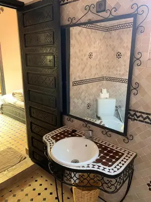 a bathroom with a sink and a mirror at Riad jmiaa in Marrakech