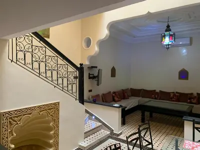 a living room with a couch and a staircase at Riad jmiaa in Marrakech