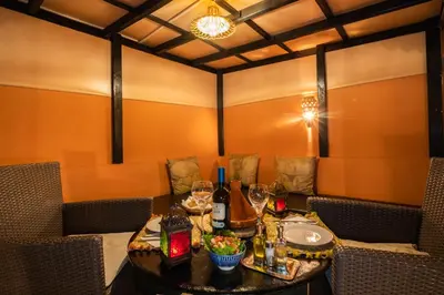 a dining room with a table with wine bottles at Riad Azcona in Marrakech