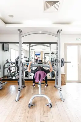 a person in a gym doing a barbellstack at Kenzi Menara Palace & Resort in Marrakech