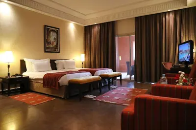 a hotel room with a bed and a television at Kenzi Menara Palace & Resort in Marrakech