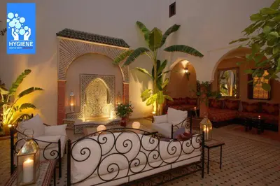 a living room with a bed and a couch at Riad petit Karmela in Marrakech