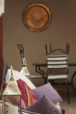a room with a bed and a chair and a table at Riad petit Karmela in Marrakech