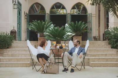 a man and a woman sitting at a table at Les Deux Tours in Marrakech