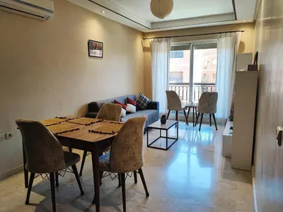 a living room with a table and a couch at Bright Apt in the Heart of Marrakech-Walk Everywhere in Marrakech