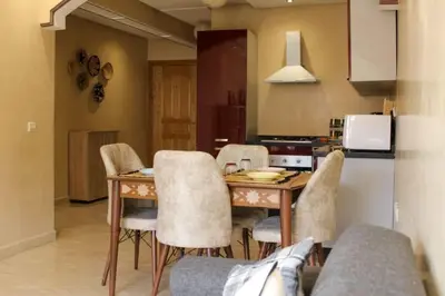 a kitchen with a table and chairs in a room at Bright Apt in the Heart of Marrakech-Walk Everywhere in Marrakech
