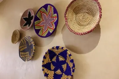 a group of plates and hats hanging on a wall at Bright Apt in the Heart of Marrakech-Walk Everywhere in Marrakech