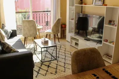 a living room with a couch and a tv at Bright Apt in the Heart of Marrakech-Walk Everywhere in Marrakech