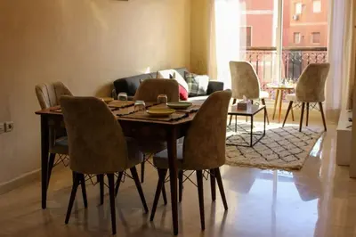 a dining room table with chairs and a couch at Bright Apt in the Heart of Marrakech-Walk Everywhere in Marrakech