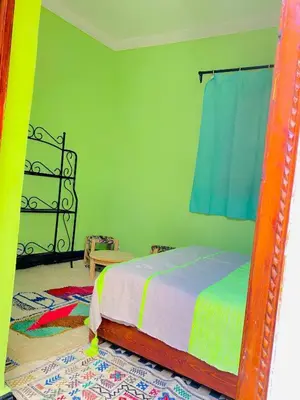 a bedroom with a bed and a mirror at RIAD GALIYA in Marrakech
