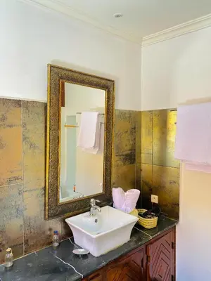 a bathroom with a sink and a mirror on the wall at RIAD GALIYA in Marrakech
