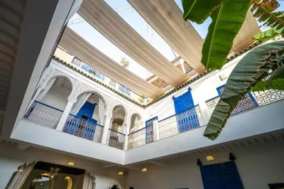 a building with blue doors and a balcony at Riad Sheba in Marrakech