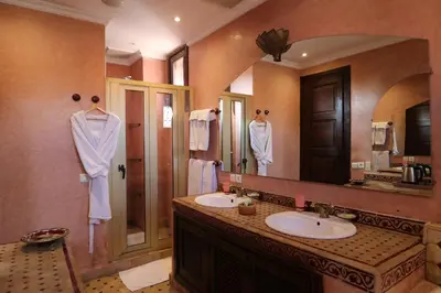a bathroom with two sinks and a large mirror at Riad Mazal in Marrakech