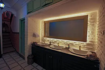 a bathroom with two sinks and a large mirror at Riad Catalina in Marrakech