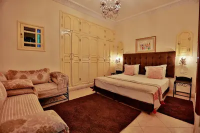 a bedroom with a bed and a couch in it at Riad Catalina in Marrakech