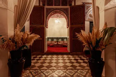 a living room with a couch and a checkered floor at Riad Catalina in Marrakech