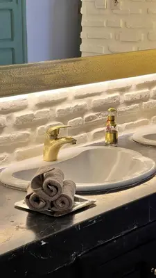 a white bathroom sink with a towel on it at Riad Catalina in Marrakech