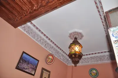 a chandelier hanging from a ceiling in a room at Hotel Agnaoue in Marrakech