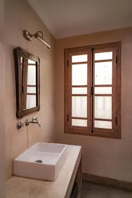 a bathroom with a white sink and a mirror at Equity Point Marrakech in Marrakech