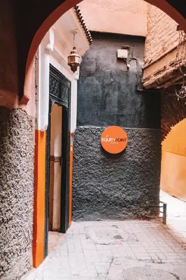 an alley with a sign on the side of a building at Equity Point Marrakech in Marrakech